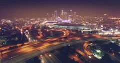 Aerial city traffic freeway night flying forward downtown Los Angeles skyline