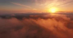 Aerial view epic low clouds over California Pacific Coast sunset flying backward