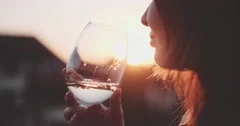 Woman Drinking Wine at the Balcony during Sunset. Slow Motion 120 fps, 4K DCi.