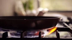 Gas stove wok burner ignited + baking pan utilized in modern design kitchen