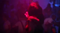 Girl dancing striptease on pylon in the night club