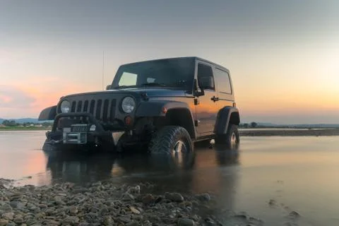 Athens, Greece 1 July 2016. Beautiful jeep 4x4 against the sunset. xkwx 4, 4x4, Greece, Oropos, action, activity, beautiful, beauty, bog, dramatic, drive, extreme, four, golden, hour, illustrative editorial, jeep, mud, mudding, off, outdoor, road, scenery, sky, sport, stuck, through, wetland, wheel, wheeling, wrangler