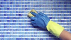 Cleaning swimming pool tile with sponge
