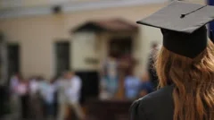 Female university student at graduation ceremony, looking into successful future