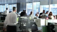 Time lapse of busy city office workers working together in large modern office