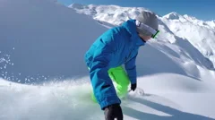 SELFIE: Extreme freeride snowboarder riding powder off-piste and falls into snow
