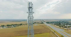 Aerial view on tower of cell phone antenna road with transportation and blue sky