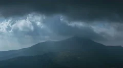 The picturesque mountain view on the background of cloud stream. Time lapse