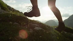 CLOSE UP: Detail of leather mountain shoes and woman climbing steep mountain