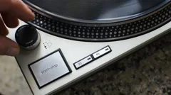 A fan of high-fidelity music starts the record player for listening to a vinyl