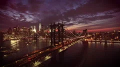 flying along Manhattan Bridge towards New York City at dusk