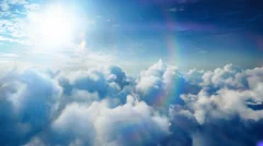 Flying over the timelapse clouds with beautiful lens flare, seamlessly looped