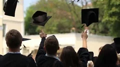Happy young people throwing academic caps up, celebrating graduation, education