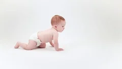 Baby crawling across white background
