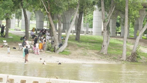 07-June-2026 Georgetown, TX - Families and kids swimming in river in public park Stock Footage 336867888