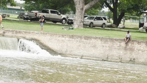 07-June-2026 Georgetown, TX - Man fishing from shore of river in public park Stock Footage 336867979