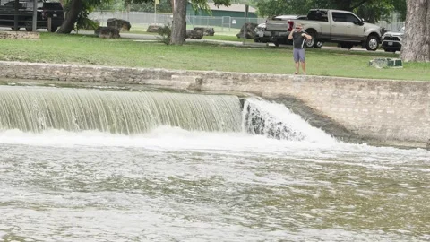 07-June-2026 Georgetown, TX - Man fishing from shore of river in public park Stock Footage 336868137