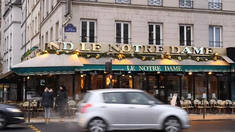 07 Rainy gray winter day Paris street traffic near facade of Notre Dame resta Stock Footage 100814696