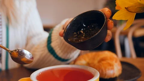 07 Slow motion adding a honey to a tea breakfast in cafe Stock Footage 103845109