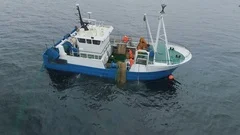 Aerial Shot of a Commercial Ship Fishing with Trawl Net at the Sea.