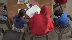 Indian mother helps her children kids with school homework, India