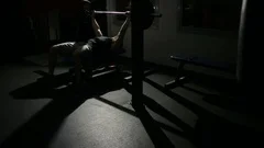 athlete man does bench press from chest exercise in gym hall