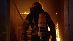 Brave Firefighter Runs Up The Stairs. In Slow Motion. Raging Fire Everywhere