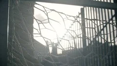 Sun is shining though soccer gates or net at the abandoned empty football field