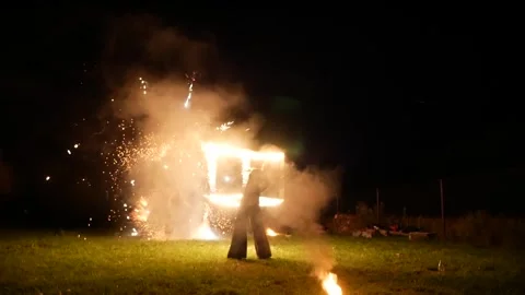 07.22.2026 - Gomel, Belarus: Skilled performers rotate a large burning geomet Stock Footage 335522846