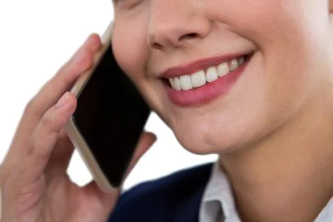 Close-up of smiling businesswoman talking on mobile phone xkwx 20s, Young Adult, Woman, Female, Caucasian, Studio Shot, White Background, Businesswoman, Business, Career, Professional, Profession, Occupation, Job, Corporate, Expertise, Leadership, Well Dressed, Holding, Smiling, Cheerful, Happy, Calling, On The Phone, Phoning, Phone Call, Talking, Conversation, Interacting, Speaking, Discussion, Smartphone, Mobile Phone, Cellphone, Phone, Wireless Technology, Communication, Connection, Beautiful, Pretty
