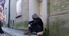 4k, Young woman offering a blanket to a homeless man. Slow motion