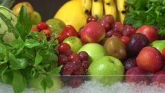 closeup of fruits and vegetables that are watered and placed on ice