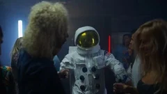 4K Party crowd dancing in the club, funny astronaut dancing & kissing a girl