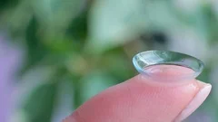 Macro filming a contact lens on a finger, HD footage