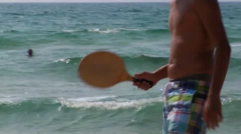 073 MAN PLAYING MATKOT CAESAREA BEACH Stock Footage 10809544