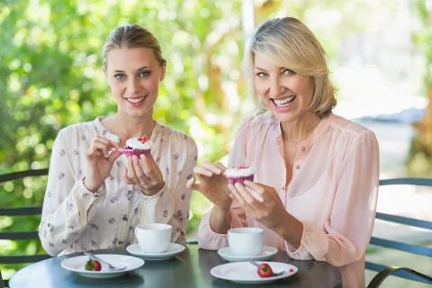 Portrait of smiling friends enjoying coffee together at restaurant xkwx Woman, Female, Caucasian, 50s, Mature Adult, Restaurant, Coffee Shop, Hotel, Food And Drink Industry, Retail, Business, Customer, Casual Clothing, Sitting, Table, Chair, Plate, Sweet Food, Snack, Dessert, Indulgence, Temptation, Delicious, Tasty, Smiling, Cheerful, Happy, Coffee, Coffee Cup, Saucer, Drink, Beverage, Refreshment, Friend, Friendship, Enjoyment, Joy, Fun, Together, Bonding, Confident, Confidence, Beautiful, Attractive, Pretty, Leisure, Lifestyle, REUNITEDP5BRIEF