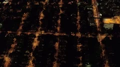 AERIAL Suburban - urban street grid lit up with lights at night in New York City