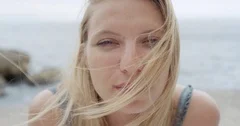 Close up portrait of beautiful Young Woman Blonde hair blowing in wind on