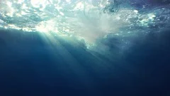 Beautiful underwater sea view with natural light rays in slow motion