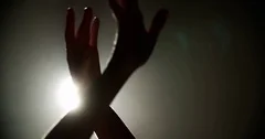 Ballerina dancing on stage, close-up of only hands with magic light on