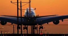 Passenger commercial airbus jet airplane landing in airport at sunset 4K, RAW