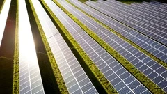 Solar farm panels in the sunlight; aerial drone