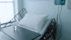 A empty bed in a hospital room during the day, tracking shot, slow motion, 4K
