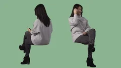 Brunette woman is sitting and talking by cellphone. Pre-keyed green screen video