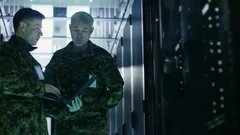 In Data Center Two Military Men Work with Open Server Rack Cabinet. 