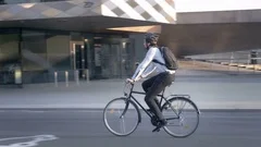 Businessman wearing formal clothes riding a bike on his commute