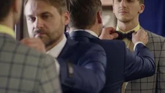 Male Sales Assistant Helping Customer with Bowtie