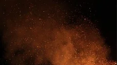 Burning ash rise from large fire in the night sky - slow motion