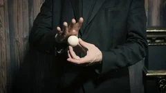 Magician shows a performance with playing cards