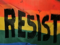 Resist sign Rainbow flag waves blowing Activism slow motion LGBTQ gay pride